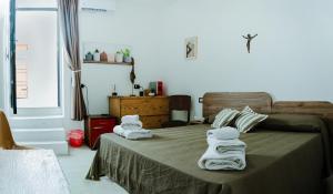a bedroom with two beds with towels on them at Ci Thorno Hotel in Crosia