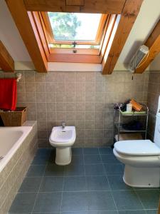 een badkamer met een toilet, een wastafel en een bad bij Alojamiento Turístico Prellezo in Prellezo