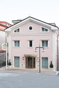a large pink building on a street at Hotel SAN PIO in San Giovanni Rotondo