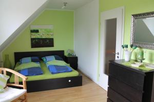 a bedroom with a bed with a mirror and a dresser at Ostseelicht in Zierow