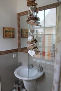 a bathroom with a sink and a towel rack at Ostseelicht in Zierow