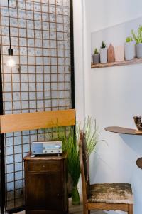 a room with a wooden chair and a table and some plants at Ci Thorno Hotel in Crosia +150 photos