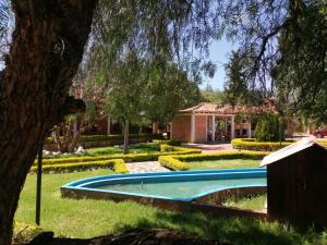 a swimming pool in the yard of a house at Hotel Hacienda Santa Cecilia in Sáchica