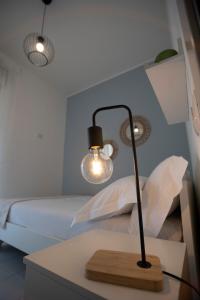 una lámpara en una mesa junto a una cama en Pausa Mare Seaside, en Torre a Mare