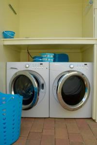 a washer and dryer sitting in a laundry room at Endless Summer in Palm-Eagle Beach