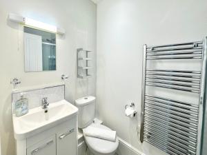 a white bathroom with a toilet and a sink at Moorgate View - Free on street Parking in York