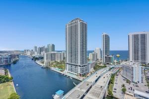 a view of a city with a river and buildings at Stunning Beach Resort Large 4BR 3BA Condo 24 FL in Hallandale Beach