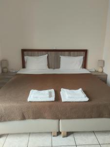 a large bed with two white towels on it at Panorama in Elafonisi