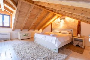 a bedroom with a large bed in a room with wooden ceilings at Holiday house with a swimming pool - Villa Melavita in Stari Grad +32 photos