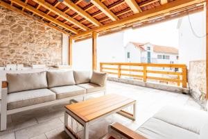 a living room with a couch and a table at Holiday house with a swimming pool - Villa Melavita in Stari Grad