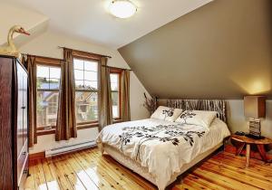 a bedroom with a bed and a large window at 9020 Chemin des Alpages in Stoneham