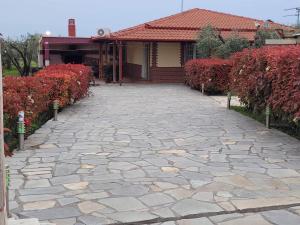 a stone driveway in front of a house at Narcis House in Thessaloniki