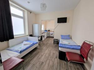 a small room with two beds and a tv at Central located Apartments in Bergisch Gladbach