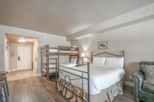 a bedroom with a bunk bed and a chair at Studios in Gateway Lodge in Keystone