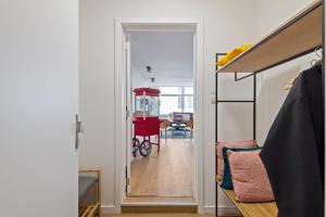 a hallway with a door leading to a room at Cozy Antwerp - City Family Apartment with Parking in Antwerp
