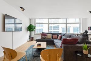 a living room with a couch and a table at Cozy Antwerp - Cityview Family Apartment FREE PARKING in Antwerp