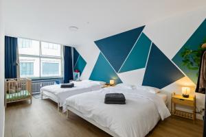 a bedroom with two beds and a geometric wall at Cozy Antwerp - Cityview Family Apartment FREE PARKING in Antwerp