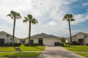 a family house with palm trees in the driveway at Gated Community!! Sparkling Private Pool, Near Disney in Kissimmee