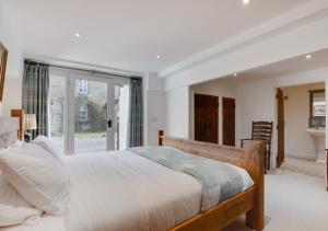 a bedroom with a bed and a large window at Mullions Nook in Buckden