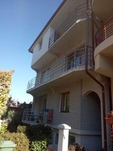 a large building with balconies on the side of it at Guest House - Apartment Kozle in Skopje