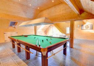 a pool table in a room with a ceiling at Wagtail Cottage in Tosside