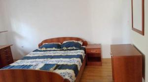 a bedroom with a bed and a nightstand and a bed sidx sidx sidx sidx at Guest House - Apartment Kozle in Skopje