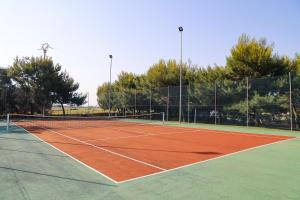 a tennis court with a net on top of it at Calanca Apulian Residence in Torre Santa Sabina