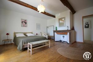 a bedroom with a bed and a fireplace at Le Bila in Troncens