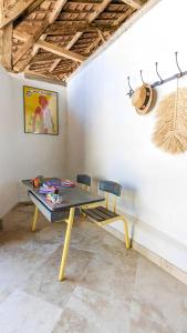 einen Tisch und Stühle in einem Zimmer mit einer Decke in der Unterkunft Le Bila in Troncens