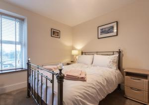 a bedroom with a bed and a window at Wilmer House in Hawes