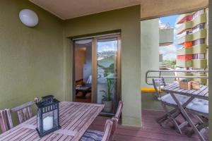 a dining room with a table and a balcony at Maria Beach in Platja  d'Aro