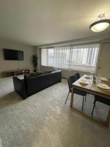 a living room with a couch and a table at Charming condo in Crystal City With Amazing Amenities in Arlington