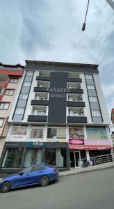 a blue car parked in front of a building at Kanarya Apart in Trabzon