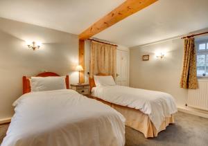 Ένα ή περισσότερα κρεβάτια σε δωμάτιο στο Barn Owl Cottage