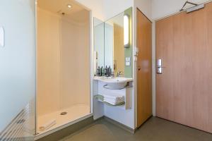 a bathroom with a sink and a shower at Hotel ibis Budget Porto Gaia in Vila Nova de Gaia
