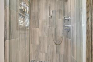 a shower stall with a glass door with a shower at Moses Lake Vacation Rental with Hot Tub and Game Room in Moses Lake +34 photos
