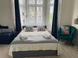 a bedroom with a bed with two towels on it at Sopot Monte Cassino Wiktoria Apt in Sopot
