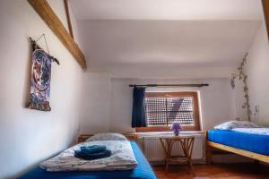 a bedroom with two beds and a window at Ranč Červený mlýn in Lisov