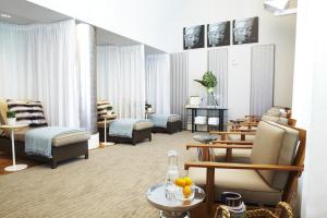 a living room with chairs and tables in a room at Huntington Hotel in San Francisco