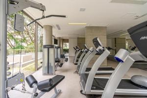 a gym with a row of treadmills and ellipticals at Tabas - VN Ferreira Lobo in São Paulo