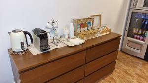 a wooden dresser with a coffee maker on top of it at Hostal Rio De Castro in Barcelona