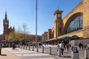 a city street with a clock tower and a building at Lovely Entire Flat in Kings Cross in London