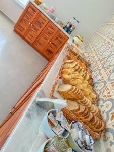 a table with bread and other food items on it at Pousada Aquino Mar in Paraty