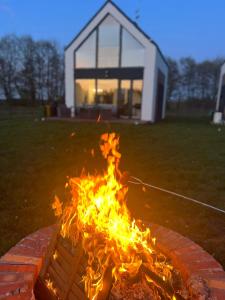 a fire pit in front of a house at Domek u Gajka Słajszewo in Słajszewo