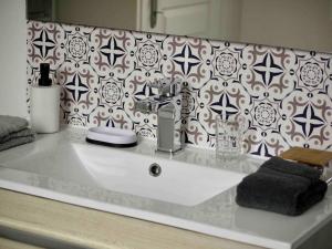 a bathroom counter with a sink and a wallpaper at L’Accostage in Dieppe