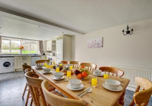 a dining room with a wooden table and chairs at Cuckoos Nest in Tosside