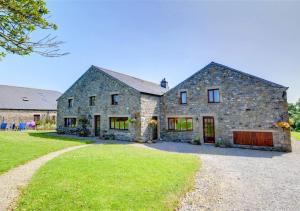 a large stone house with a large yard at Cuckoos Nest in Tosside