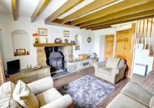 un salon avec un canapé et une cheminée dans l'établissement 2 Bransdale Cottage, à Glaisdale 3 autres photos