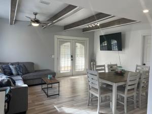a living room with a table and a couch at 1st floor apt 3 bed/ 2 bath in downtown orlando in Orlando