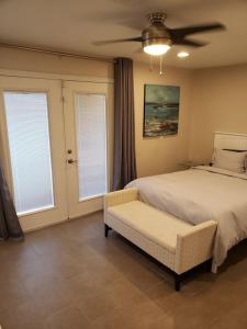 a bedroom with a bed and a ceiling fan at Luxury Villa, with bonus pool house, Private Pool, Hot tub, rock water fall and slide, putting green, basketball, shuffle board, play gym, privately gated on circular driveway. in Las Vegas +39 photos